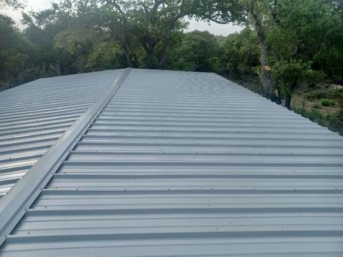 Commercial standing rib metal roof installation and ridge capping