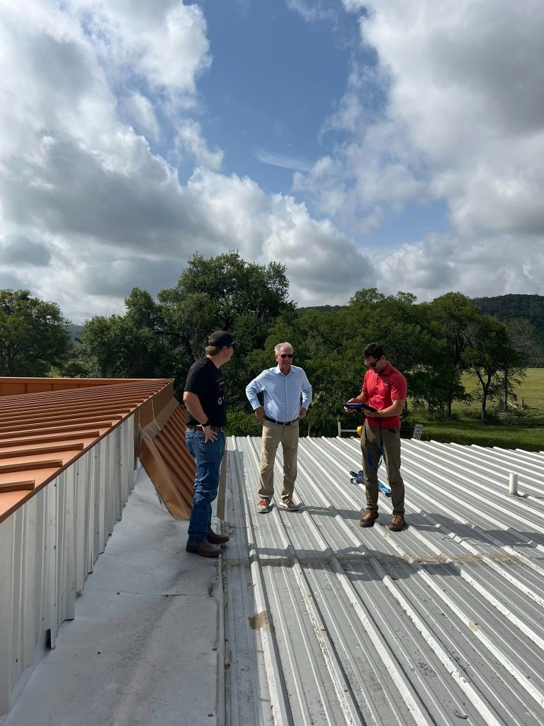 Commercial roofing team conducting on-site digital inspection and structural evaluation