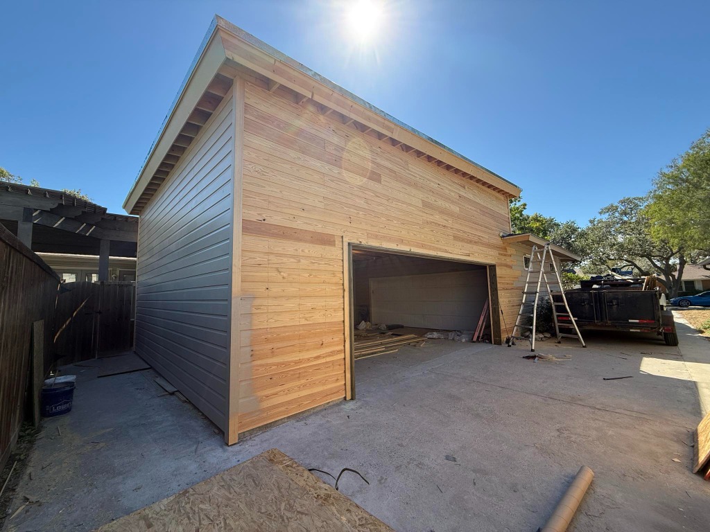 Custom wood siding and garage structural framing addition