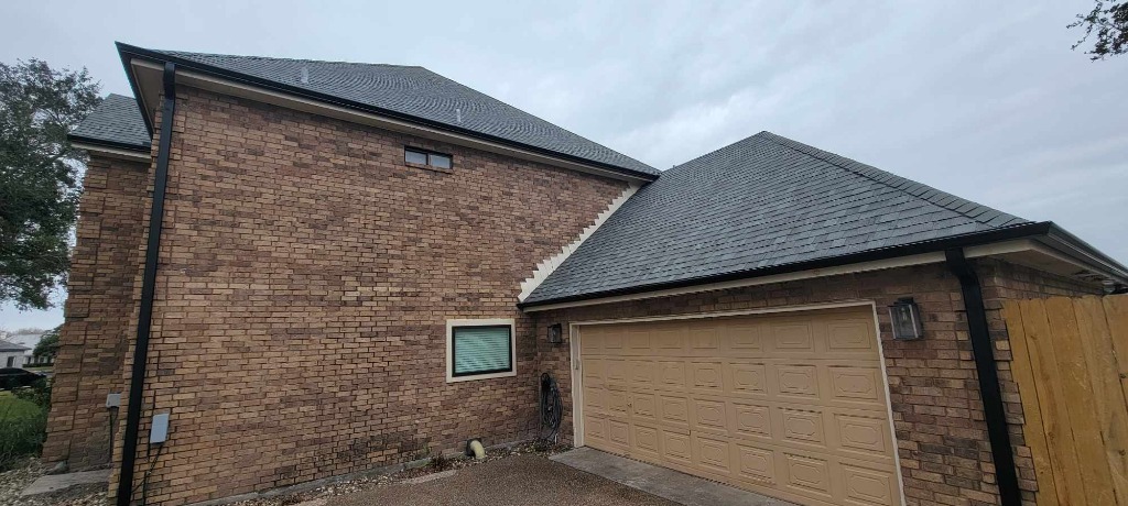 Two-story brick home roof replacement with custom step flashing and gutters