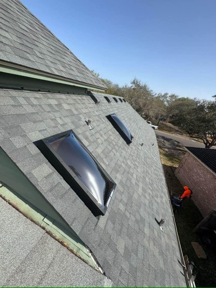 Residential roof installation featuring custom skylights and optimal ridge ventilation